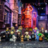 All of the figures included in the “Harry Potter” group of LEGO minifigures pose in front of Diagon Alley at the Studio Tour.