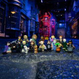 All of the figures included in the “Harry Potter” group of LEGO minifigures pose in front of Diagon Alley at the Studio Tour.