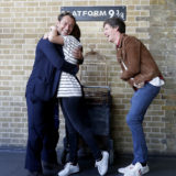 A lucky fan gives Law a hug as Redmayne laughs.