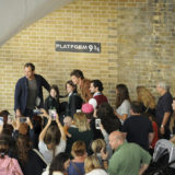 Law and Redmayne pose with two young fans celebrating Back to Hogwarts Day.