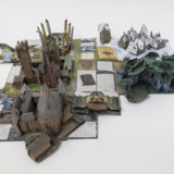 Inside pages of “Harry Potter; A Pop-Up Guide to Hogwarts” showing pop-ups of Hogwarts Castle, the Quidditch pitch, the Forbidden Forest, and Hogsmeade