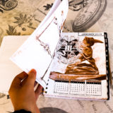 January 2019 page from the Harry Potter weekly planner showing the Hogwarts school crest and a sketch of the Sorting Hat