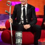 Eddie Redmayne sported a boot from an on-set injury during his interview on “The Graham Norton Show”.