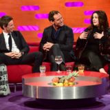 Eddie Redmayne and Jude Law listen to Melissa McCarthy speak.