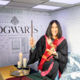 Eva Chen is dressed in Gryffindor House colors, ready to cast a spell.