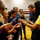 Eddie Redmayne and Zoë Kravitz from “Fantastic Beasts: The Crimes of Grindelwald” hand out prizes to students to help celebrate Wizarding World Day at Parkside Middle School in Baileyton, AL.  (Photo by Butch Dill/Getty Images)