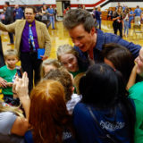 Eddie Redmayne from “Fantastic Beasts: The Crimes of Grindelwald” says goodbye to students after helping them celebrate Wizarding World Day at Parkside Middle School in Baileyton, AL.  (Photo by Butch Dill/Getty Images)