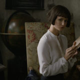 Tina looks up from her book.