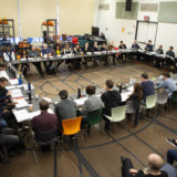 The actors gather to read the script.