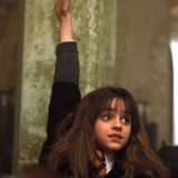 Hermione raises her hand to answer a Potions question.