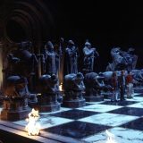 Harry, Ron, and Hermione begin playing a game of giant wizard chess on their path to the Sorcerer’s Stone.