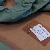 A close-up shot of my “packaged by” card. I thought it was a good sign that my print was packaged by someone named Ron!