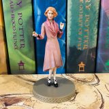 Queenie’s signature pink overcoat is on full display, as shown in this photograph.