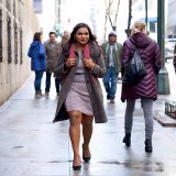 Mindy Kaling walks down the street with purpose in this still from “Late Night”.