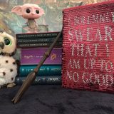 Harry Potter: Manage Your Mischief Marauder’s Map Sequin Notebook displayed with “Harry Potter” books, wand, owl, and Dobby figurine