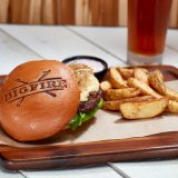 The signature bison burger comes with a side of fries and the restaurant’s logo seared into the bun.