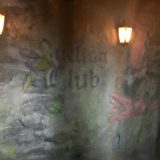 On either side of this “Dueling Club” notice is a dragon. The original ride in this location, which was rethemed to Dragon Challenge with the opening of Hogsmeade in 2010, was named Dueling Dragons.