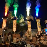 With the help of the Levitation Charm, the objects blocking the entrance to the ride are lifted out of the way as jets of red, green, yellow, and blue light and smoke shoot out above the banners.