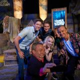 Warwick Davis takes a selfie with James and Oliver Phelps, Evanna Lynch, Rupert Grint, and Tom Felton after the conclusion of the opening celebration event.