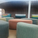 The lobby is framed by wooden waves and reception desks designed to look like surfboards.