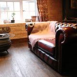 Enchantment Chamber leather couch and cauldron end table in living room