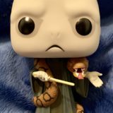 A close-up view of the Voldemort Funko Pop! figure, complete with his wand and Nagini wrapped around his neck