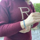 Side view and close up on the “R” in the middle of the sweater