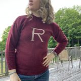 Full frontal view of the maroon “R” sweater being worn