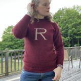 Full frontal view of the maroon “R” sweater being worn