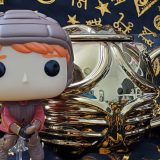Ron Weasley Funko POP!, pictured with the Harry Potter Golden Snitch Coffee Mug from Hallmark Gold Crown, lid on, back view