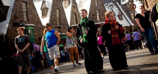 A pair of youngsters walk the streets of Hogsmeade, decked out in their House robes, at the Wizarding World of Harry Potter at Universal Orlando Resort.