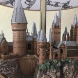 Harry Potter Hogwarts Lamp from The Bradford Exchange: close-up view of the left-hand side of the sculpture, including a tall tower, the clock tower courtyard, and the bridge.