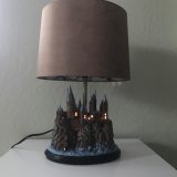 Harry Potter Hogwarts Lamp Illuminated Base: front view of the full lamp with the base illuminated
