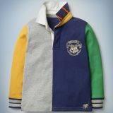 The Mini Boden Hogwarts Rugby Shirt, multi-color, has a fun patchwork feel. The shirt is collared with cuffs and features a Hogwarts crest in the front pocket area. It retails at £30.