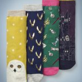 The Mini Boden Pack of Harry Potter Socks features four different designs. Hedwig’s face adorns the toe of a gold pair of socks with a white star pattern. Shiny Golden Snitches cover a navy blue pair. Iconic “Harry Potter” items, such as Luna Lovegood’s Spectrespecs and Hogwarts acceptance letters, cover a green and pink pair. An image of Hogwarts adorns a plum and gold pair. The pack retails at £18.