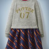 The Mini Boden Sequin Seeker Dress resembles a skirt and top and features a heather gray, long-sleeved top with gold sequins reading “Potter 07” and blue skirt bottom with red-and-gold stripes and Golden Snitches. It retails at £35.