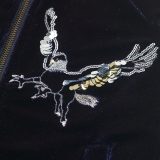 This close-up of the Mini Boden Hippogriff Bomber Jacket in blue provides a clearer view of one of the two sequined hippogriffs that adorn each breast. It retails between £50 and £56.