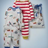 The Mini Boden Harry Potter Play Set, multi, features two top-and-bottom play outfits – one gray and featuring all-over images of Quidditch-related items, one with all-over red-and-white stripes and gold collar and pant cuffs – and a gray drawstring bag featuring Quidditch items. It retails between £35 and £38.
