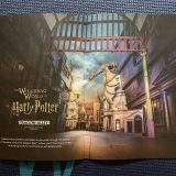 Your “Wizarding World of Harry Potter Exclusive Vacation Package” will include a special travel guide. Visible are pages describing Diagon Alley in Islands of Adventure.