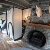 The fireplace and the cupboard under the stairs