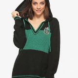 A model shows off the drawstring hood on her Slytherin sweater from Hot Topic.