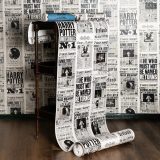 A roll of MinaLima’s “Daily Prophet” wallpaper features headlines and photos from various “Harry Potter” films.
