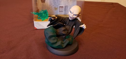Image of a vinyl figure of Voldemort, his wand at the ready, with green smoke below him and green sparks shooting from his wand.