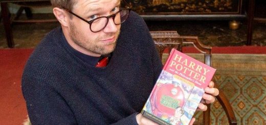 Jim Spencer holding a rare "Potter" book