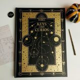 The Keys and Curios journal comes with a winged key magnetic pin and an original sketch by J.K. Rowling. You’ll have to supply your own wand and pumpkin!