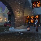 The Hogwarts Express is seen just past the glowing windows of the Three Broomsticks.