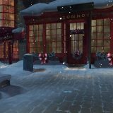 Hogsmeade is now seen by night with glowing windows and holiday decorations.