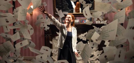 Bonnie Wright reaches for a Hogwarts acceptance letter on a set re-creation at the Warner Bros. Studio Tour Hollywood.