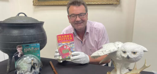 Auctioneer Richard Winterton holding the rare book (Credit: Richard Winterton Auctioneers)